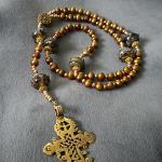 Gold fresh water pearl,(6 mm), lMurano glass roundel Paters with gold vermeil bead caps, accented with Swarovski crystals, bronze casting of antique Ethiopian cross. $ 135.00 plus $7.50 S/H