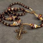 Garnet (6mm) Murano glass Paters with gold vermeil bead caps. Bronze casting of antique Miraculous medal connector and antique filigree cross. $155.00 plus $7.50 S/H